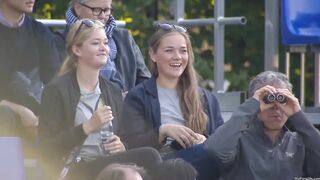 Two Danish girls having fun at an archery tournament.