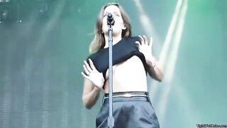 Unbound Breasts: flashes her breasts during a concert