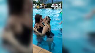 Gals Giving a kiss: Giving a kiss in the Pool