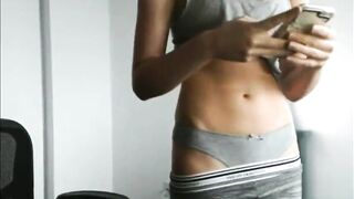 girl texting friends and exposing her young tummy
